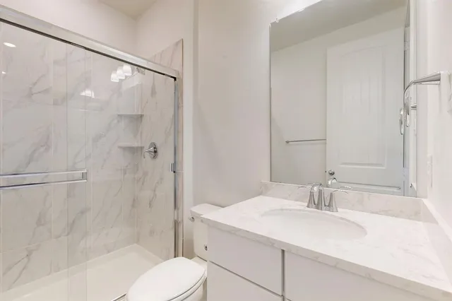 a bathroom with a sink toilet and mirror