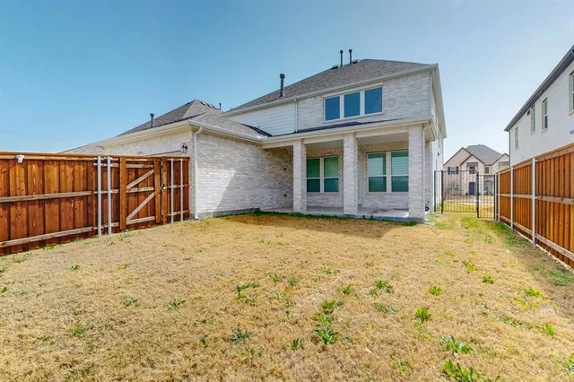 a view of a brick house with many windows