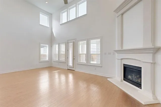 a view of an empty room with a fireplace and a window