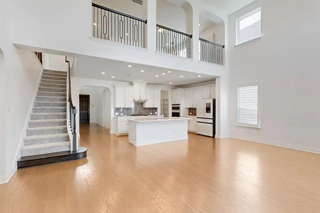 a view of an entryway with kitchen and windows
