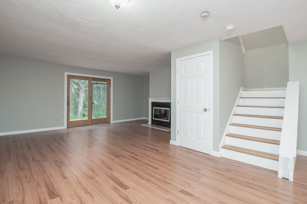 4 Shellback Way, Unit A4 Mashpee, MA 02649 - Photo 11 of 30 a view of a livingroom with wooden floor and stairs