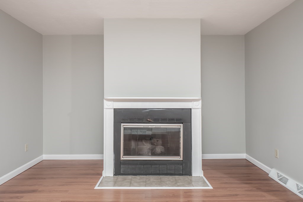 4 Shellback Way, Unit A4 Mashpee, MA 02649 - Photo 14 of 30 a an empty room with wooden floor and fireplace