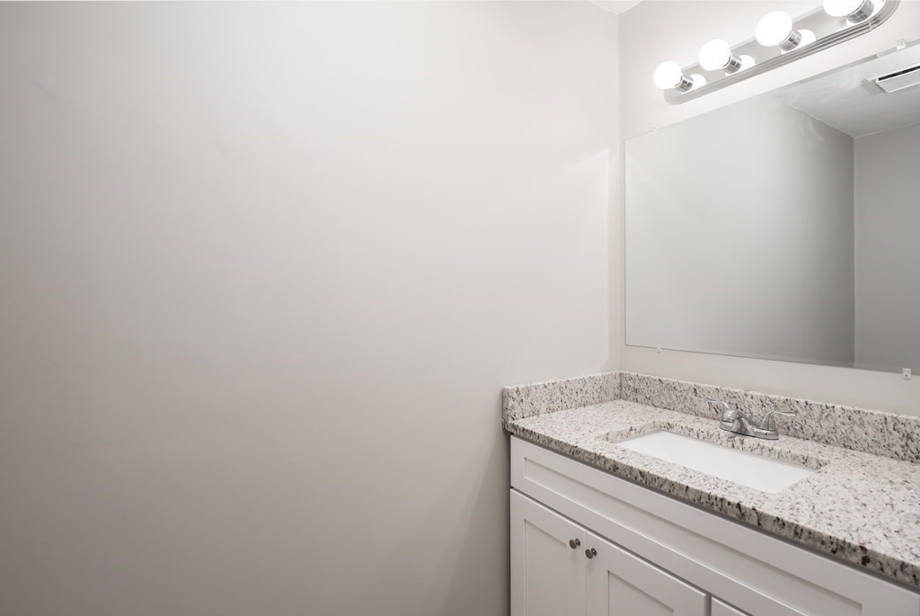4 Shellback Way, Unit A4 Mashpee, MA 02649 - Photo 15 of 30 a bathroom with a granite countertop sink and vanity