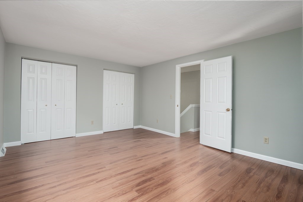 4 Shellback Way, Unit A4 Mashpee, MA 02649 - Photo 17 of 30 a view of an empty room with wooden floor and closet