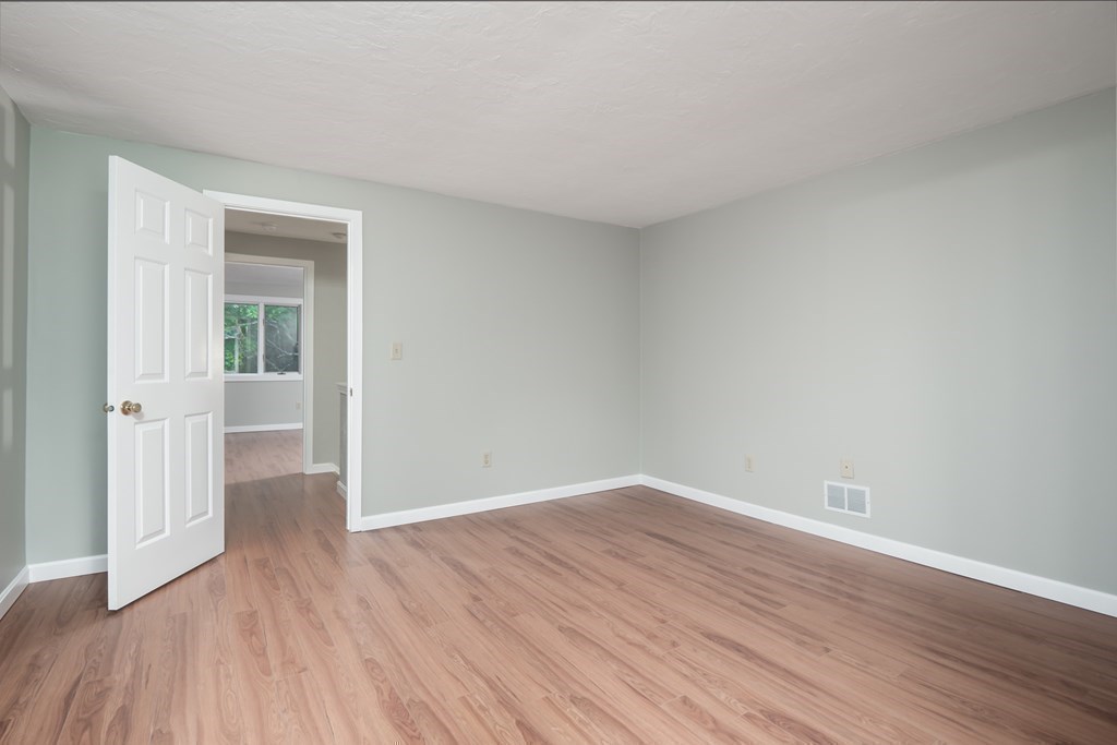 4 Shellback Way, Unit A4 Mashpee, MA 02649 - Photo 18 of 30 a view of an empty room with wooden floor