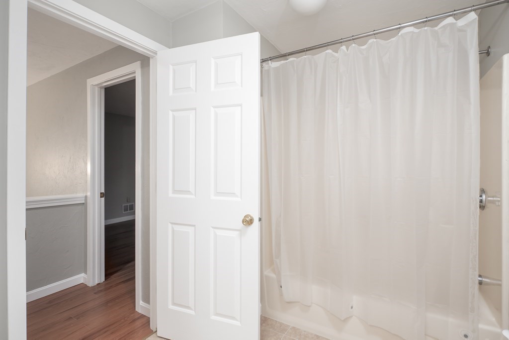 4 Shellback Way, Unit A4 Mashpee, MA 02649 - Photo 21 of 30 a bathroom with a shower and a wooden door