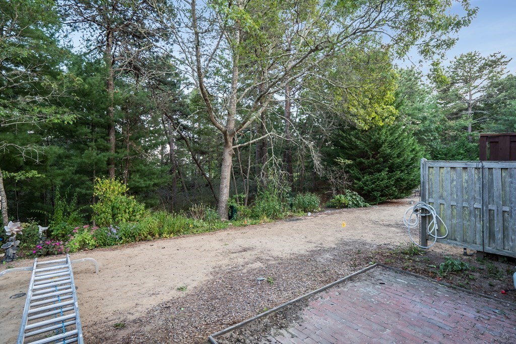 4 Shellback Way, Unit A4 Mashpee, MA 02649 - Photo 22 of 30 a view of a backyard with green space