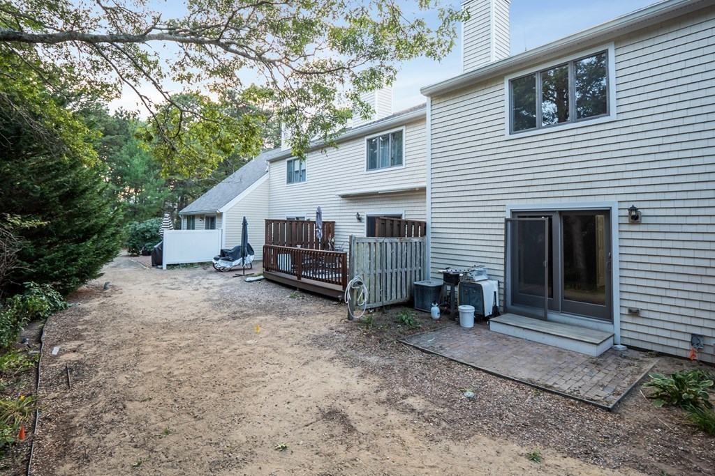 4 Shellback Way, Unit A4 Mashpee, MA 02649 - Photo 23 of 30 a view of a house with backyard and sitting area