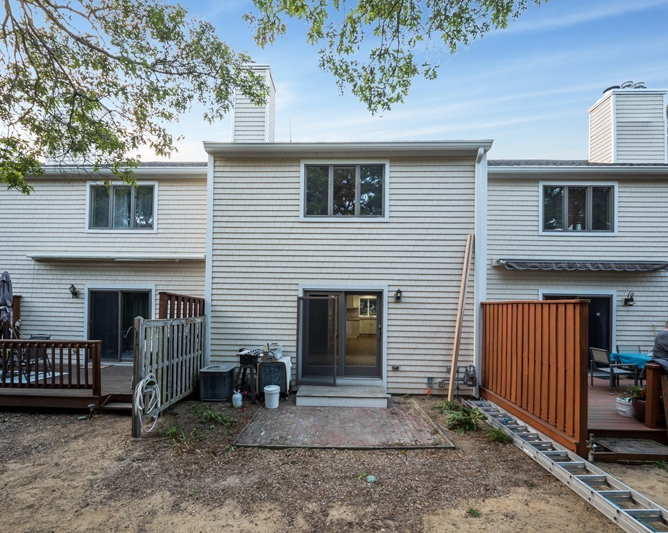 4 Shellback Way, Unit A4 Mashpee, MA 02649 - Photo 24 of 30 a view of a house with a yard and sitting area