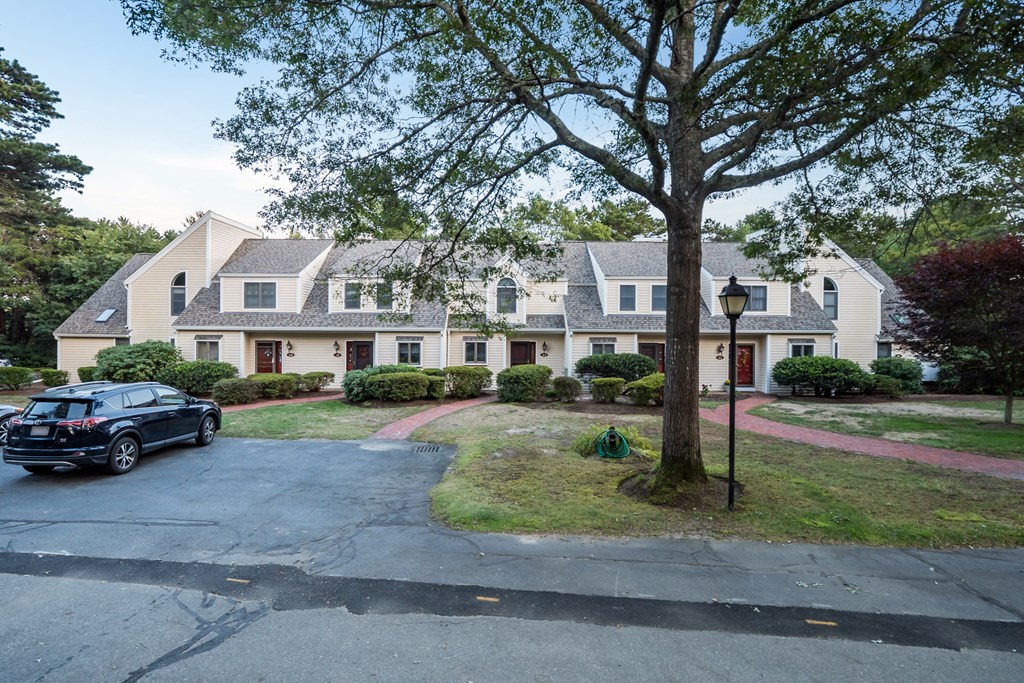4 Shellback Way, Unit A4 Mashpee, MA 02649 - Photo 30 of 30 a front view of a house with a garden and trees