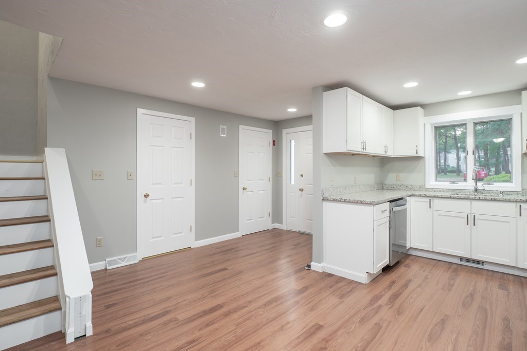 4 Shellback Way, Unit A4 Mashpee, MA 02649 - Photo 5 of 30 a kitchen with wooden floors and white appliances