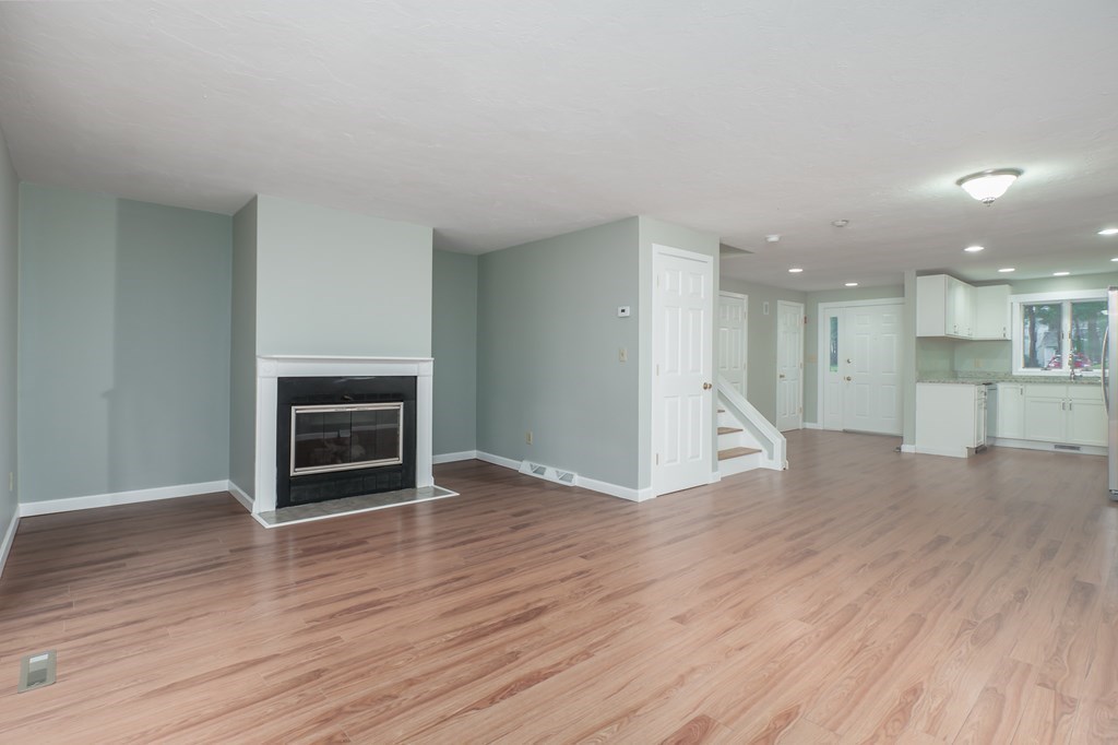 4 Shellback Way, Unit A4 Mashpee, MA 02649 - Photo 10 of 30 a view of a room with wooden floor and a kitchen