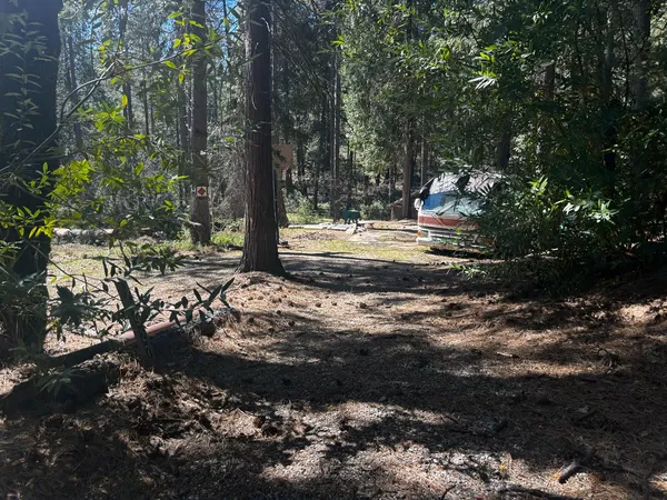 a view of a backyard with table and chairs and a fire pit