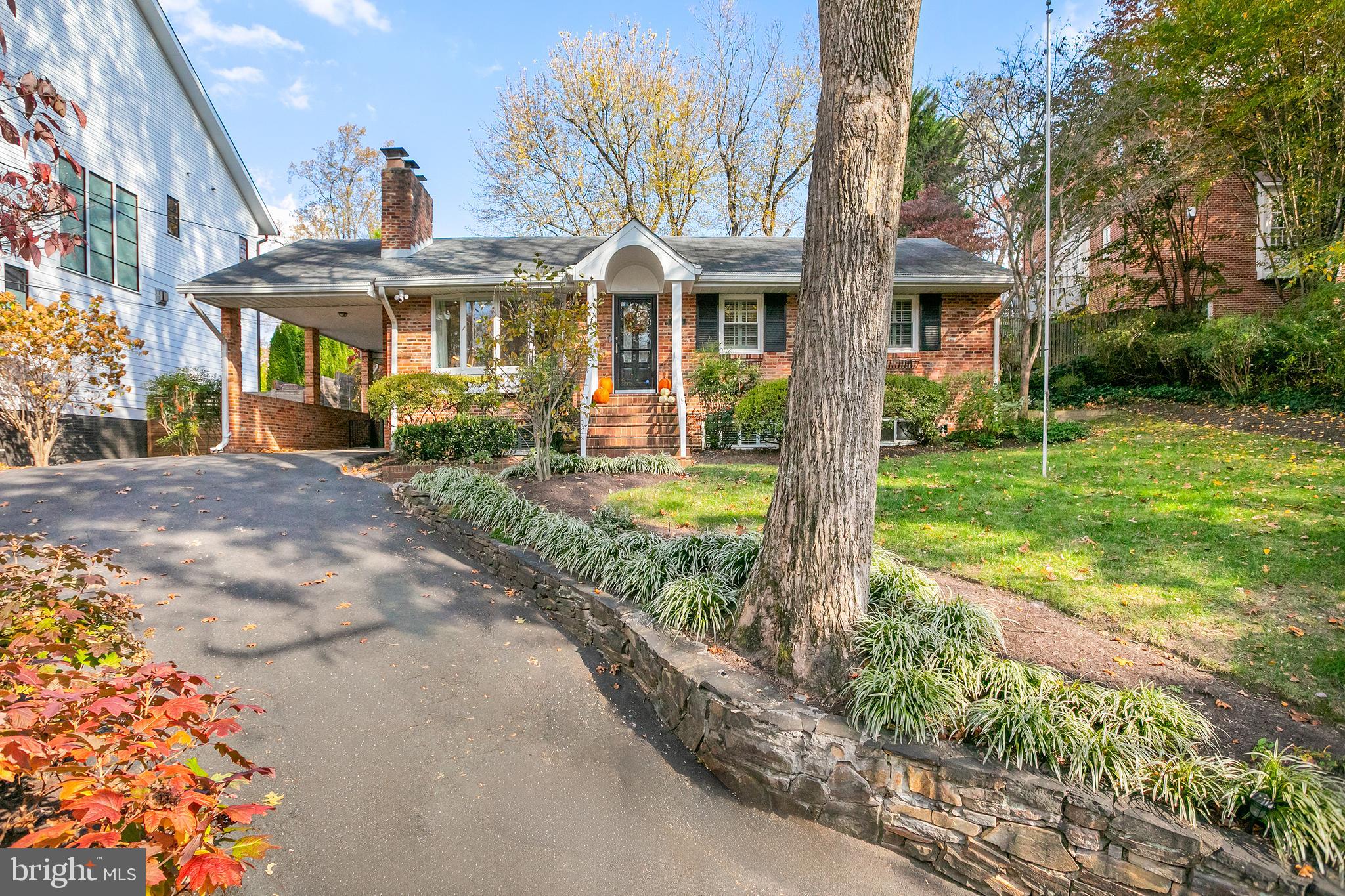 a front view of a house with garden and porch