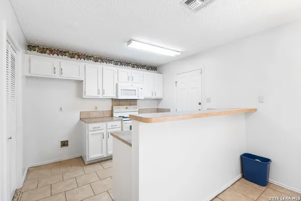 a kitchen with stainless steel appliances a sink stove and cabinets