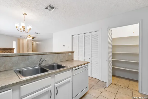 a kitchen that has a sink cabinets and window