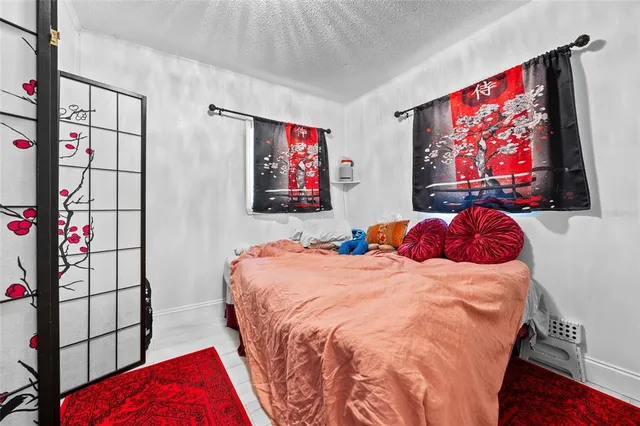 a bedroom with bed and wall painting