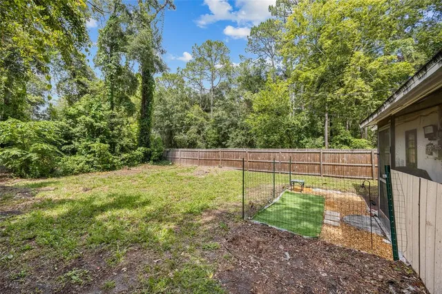 a yellow house sitting in middle of the forest