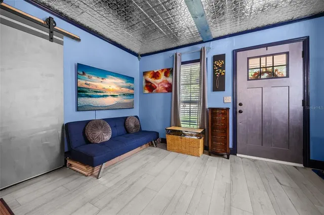 a living room with furniture and a flat screen tv