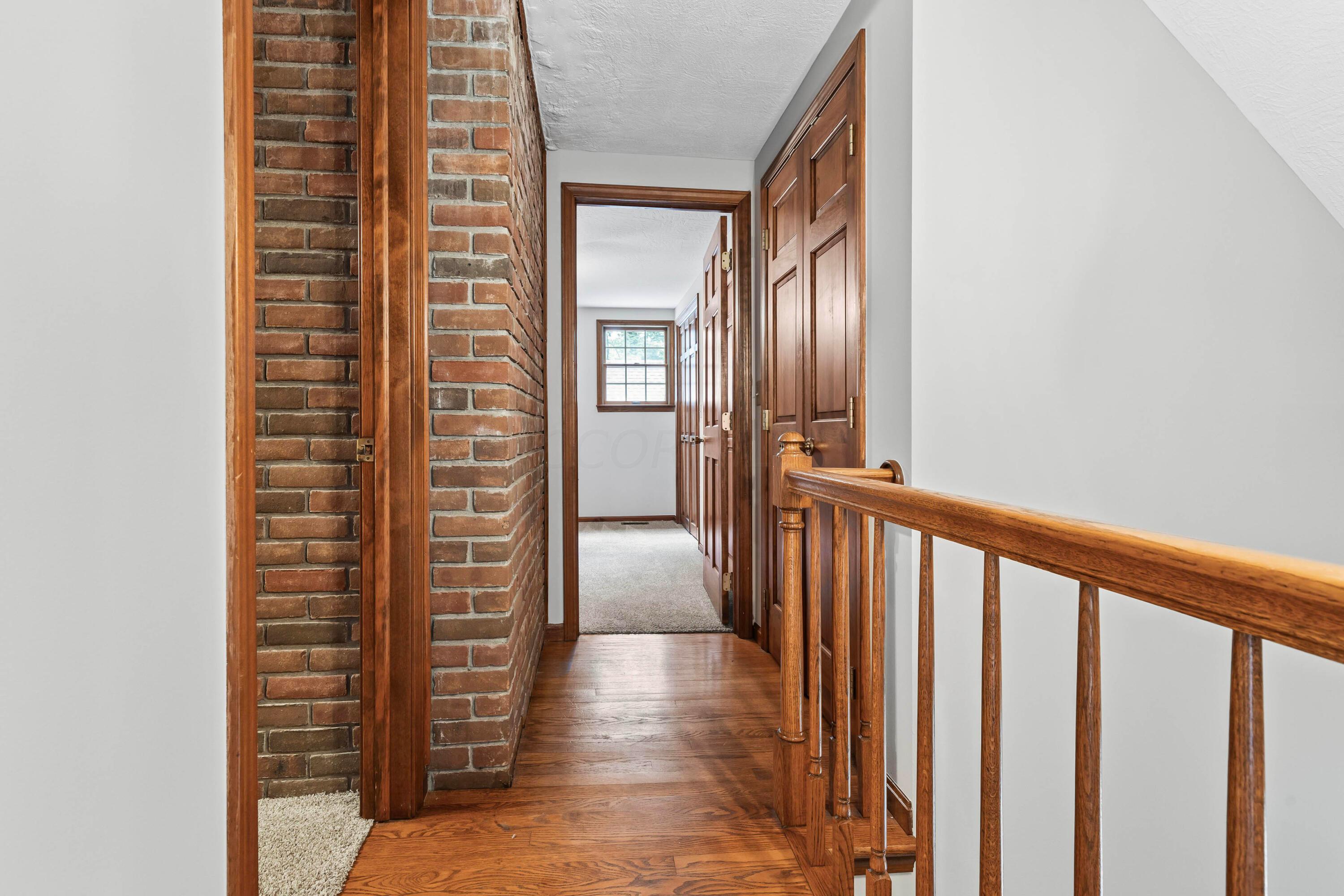 6940 Graham Road Mount Vernon, OH 43050 - Photo 39 of 70 • Hardwood flooring • Ivory painted walls • Hall linen closet