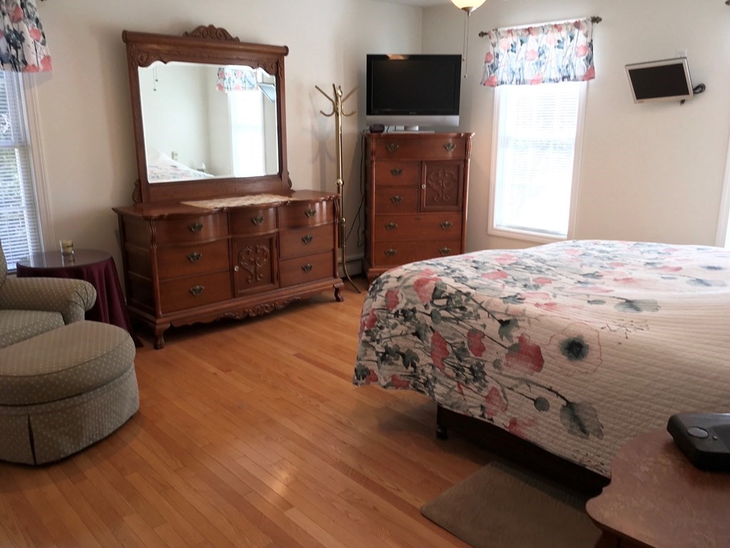 320 Putnam Hill Road Sutton, MA 01590 - Photo 17 of 40 a bedroom with a bed and a flat screen tv