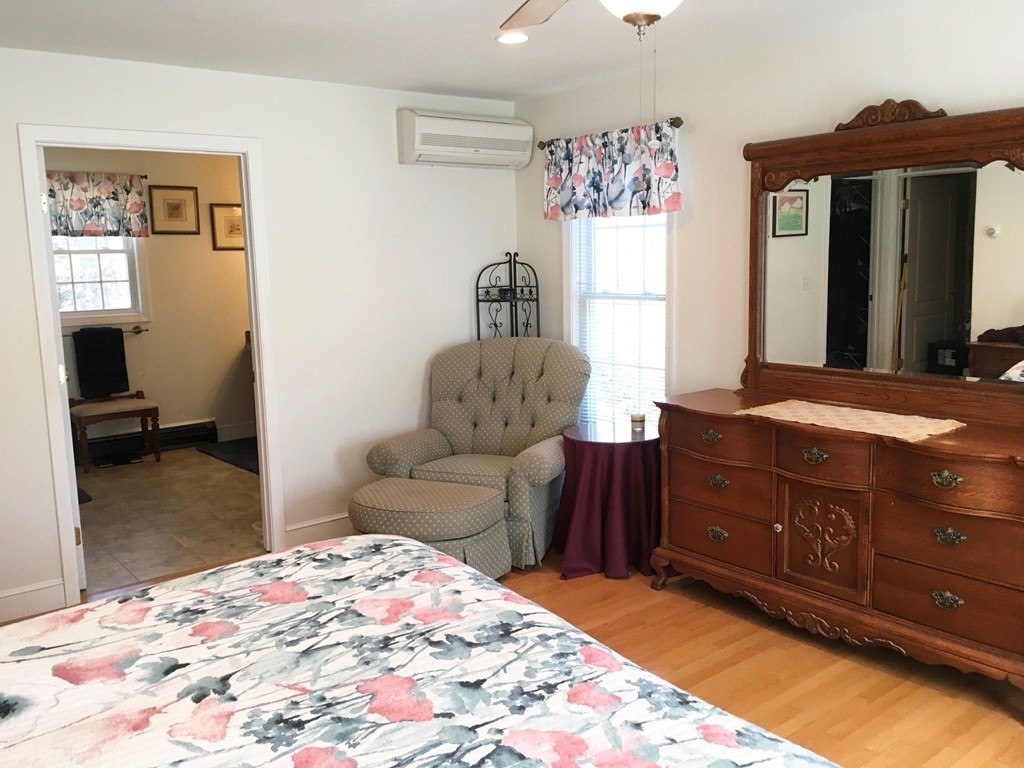 320 Putnam Hill Road Sutton, MA 01590 - Photo 19 of 40 a bedroom with a bed and wooden floor