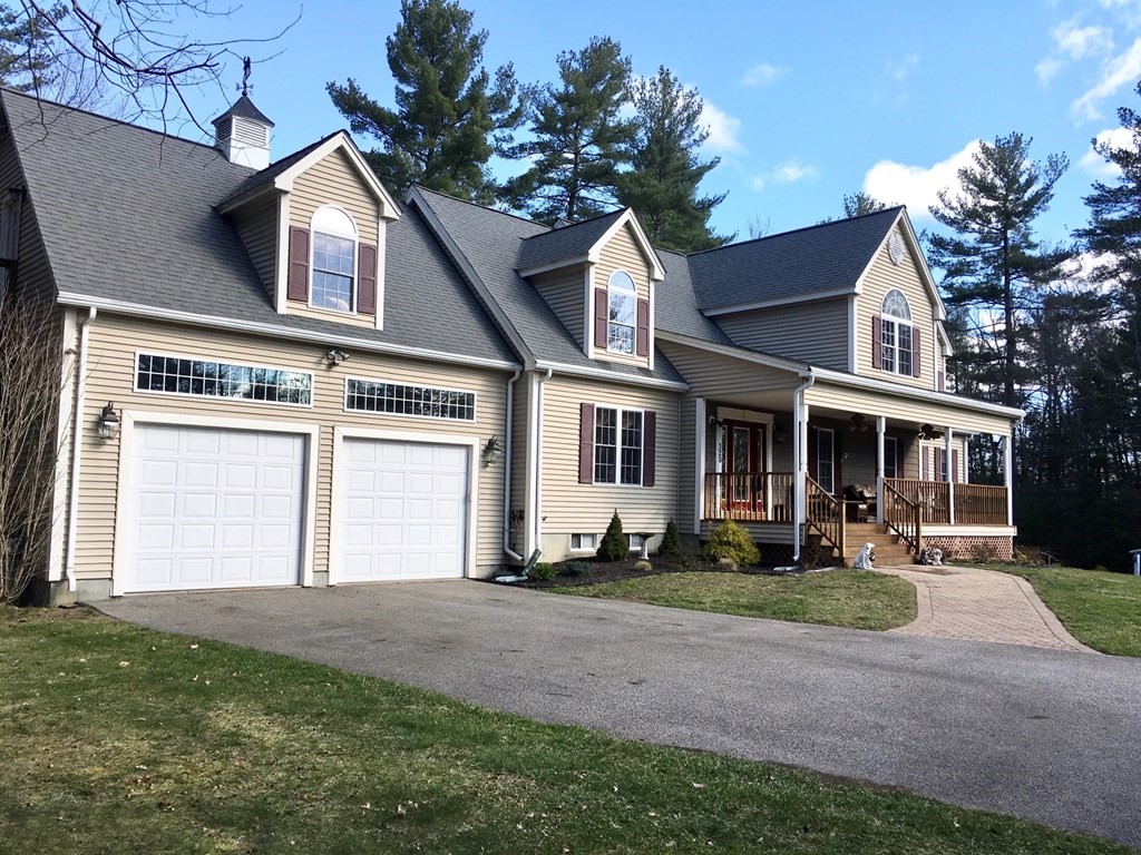 320 Putnam Hill Road Sutton, MA 01590 - Photo 2 of 40 a front view of a house with a yard