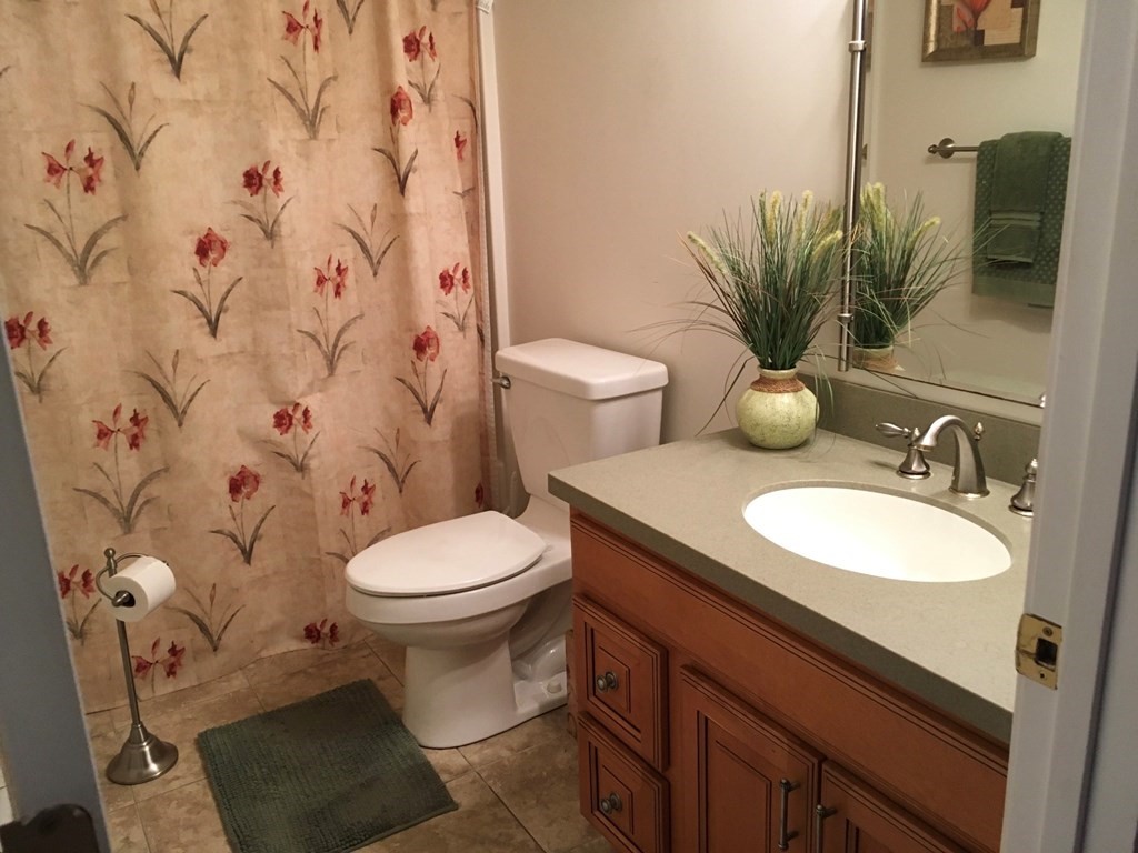 320 Putnam Hill Road Sutton, MA 01590 - Photo 25 of 40 a bathroom with a granite countertop sink and a mirror with toilet