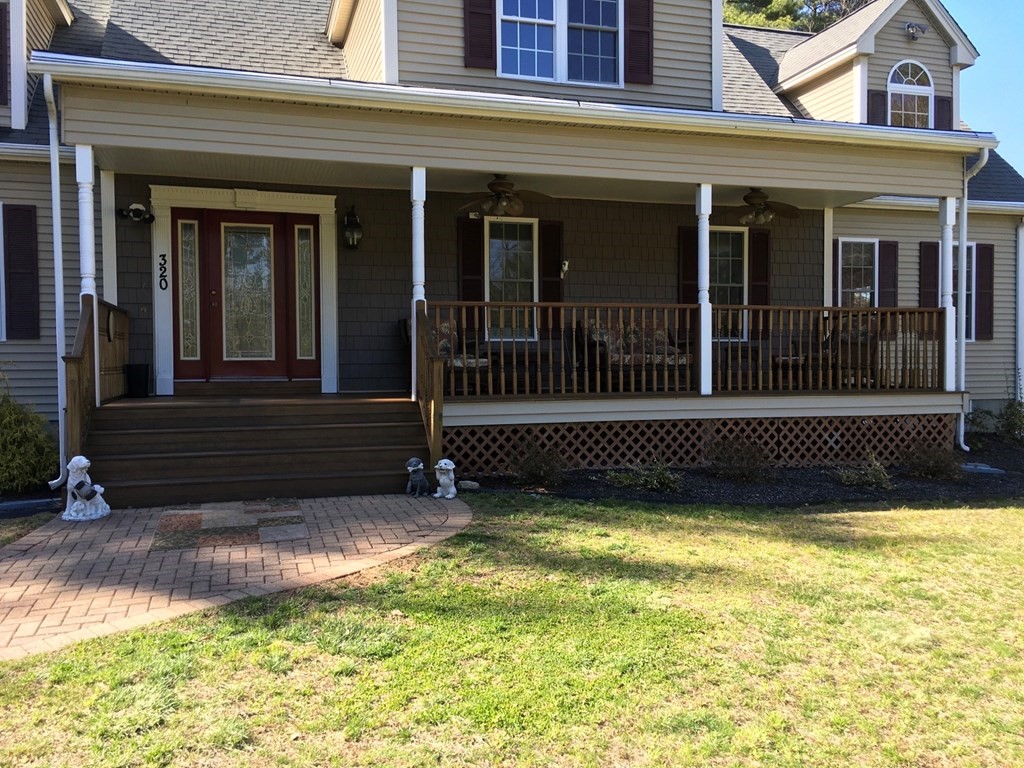 320 Putnam Hill Road Sutton, MA 01590 - Photo 4 of 40 a view of a house with a small yard and wooden floor and fence