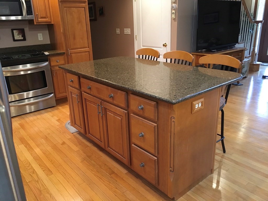 320 Putnam Hill Road Sutton, MA 01590 - Photo 7 of 40 a kitchen with stainless steel appliances granite countertop a sink and a stove