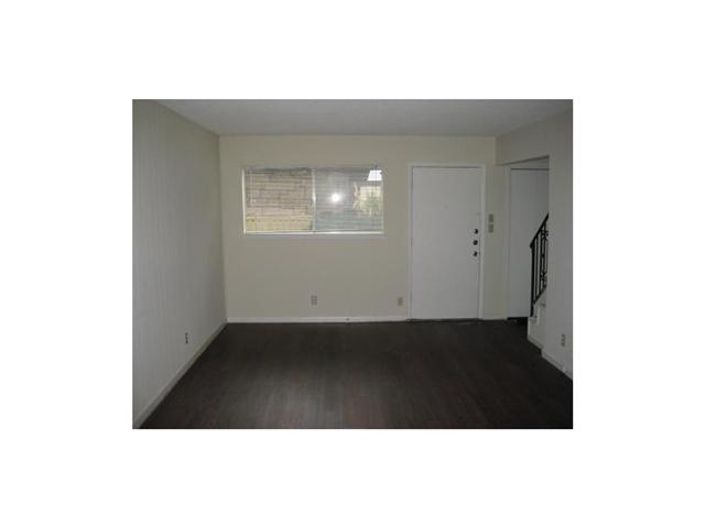 5001 Bull Creek Road, Unit 103 Austin, TX 78731 - Photo 2 of 7 Spare room with dark wood-style floors, stairway, and baseboards
