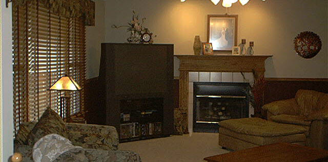 3070 North Trainer Road Rockford, IL 61114 - Photo 3 of 6 a living room with furniture a fireplace and a chandelier