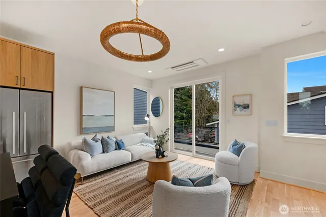 a living room with furniture a window and a chandelier