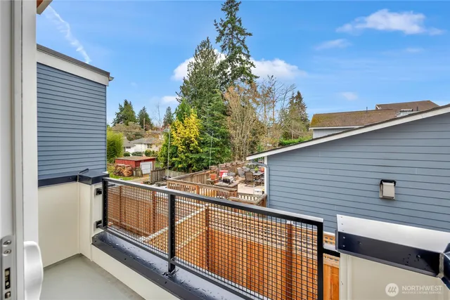 a view of a balcony with wooden fence and plants