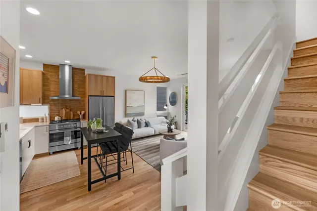 a living room with furniture and a chandelier