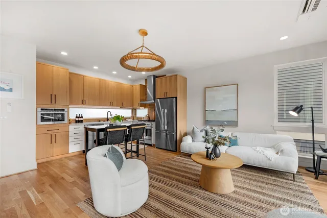 a living room with furniture a window and kitchen view