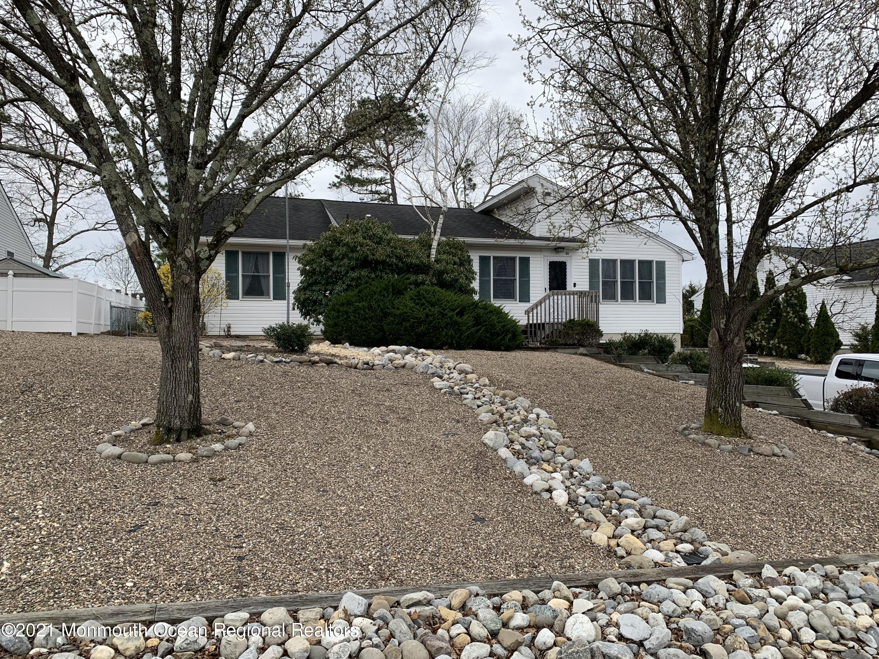 105 Seaspray Road Manahawkin, NJ 08050 - Photo 2 of 25 a tree in front of a white house