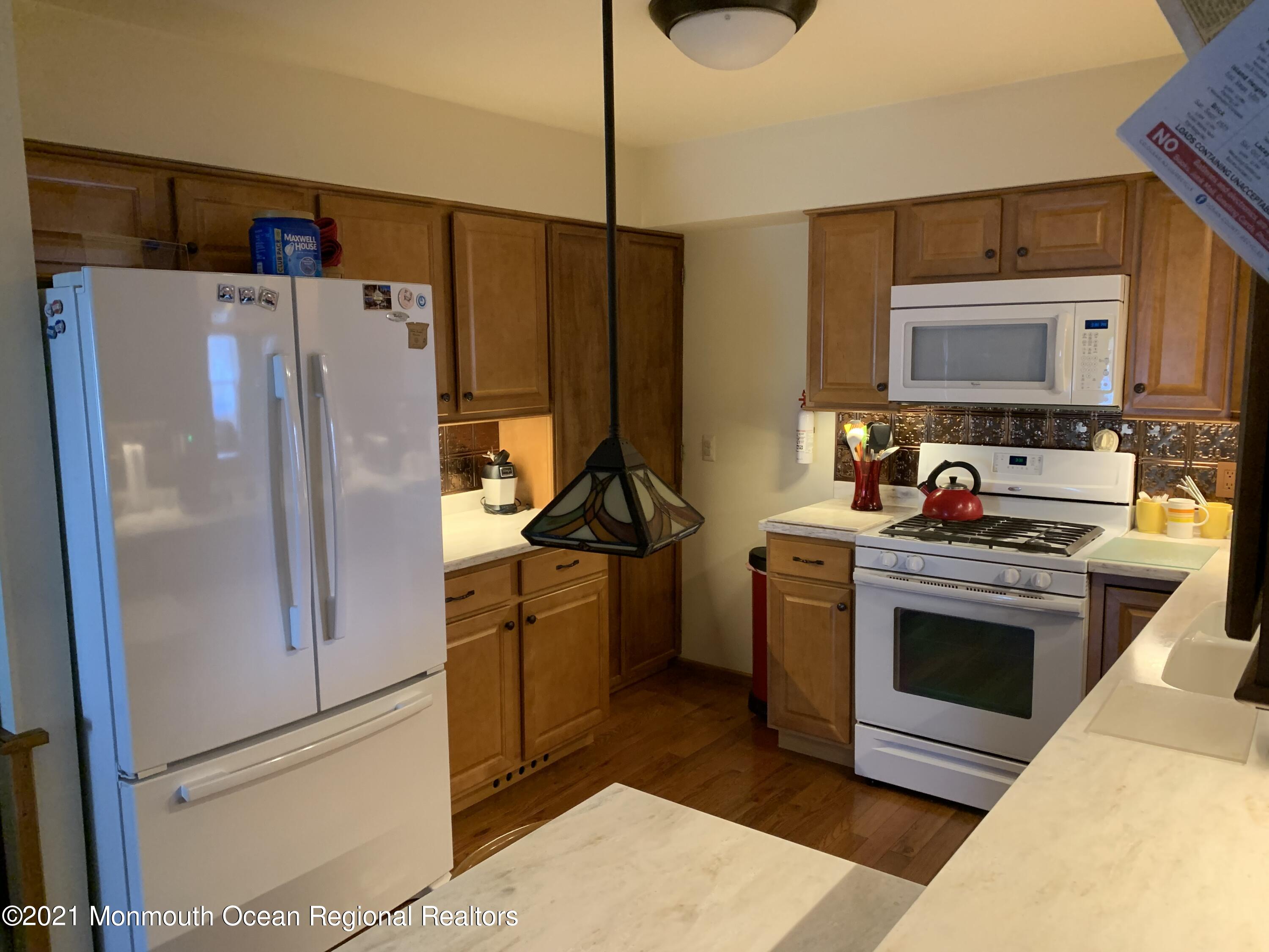 105 Seaspray Road Manahawkin, NJ 08050 - Photo 14 of 25 a kitchen with stainless steel appliances a stove a refrigerator and a sink