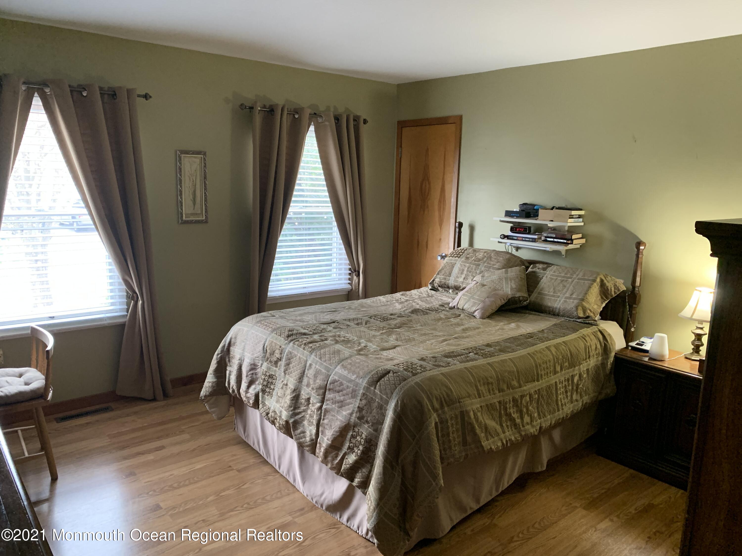 105 Seaspray Road Manahawkin, NJ 08050 - Photo 15 of 25 a bedroom with a bed and wooden floor