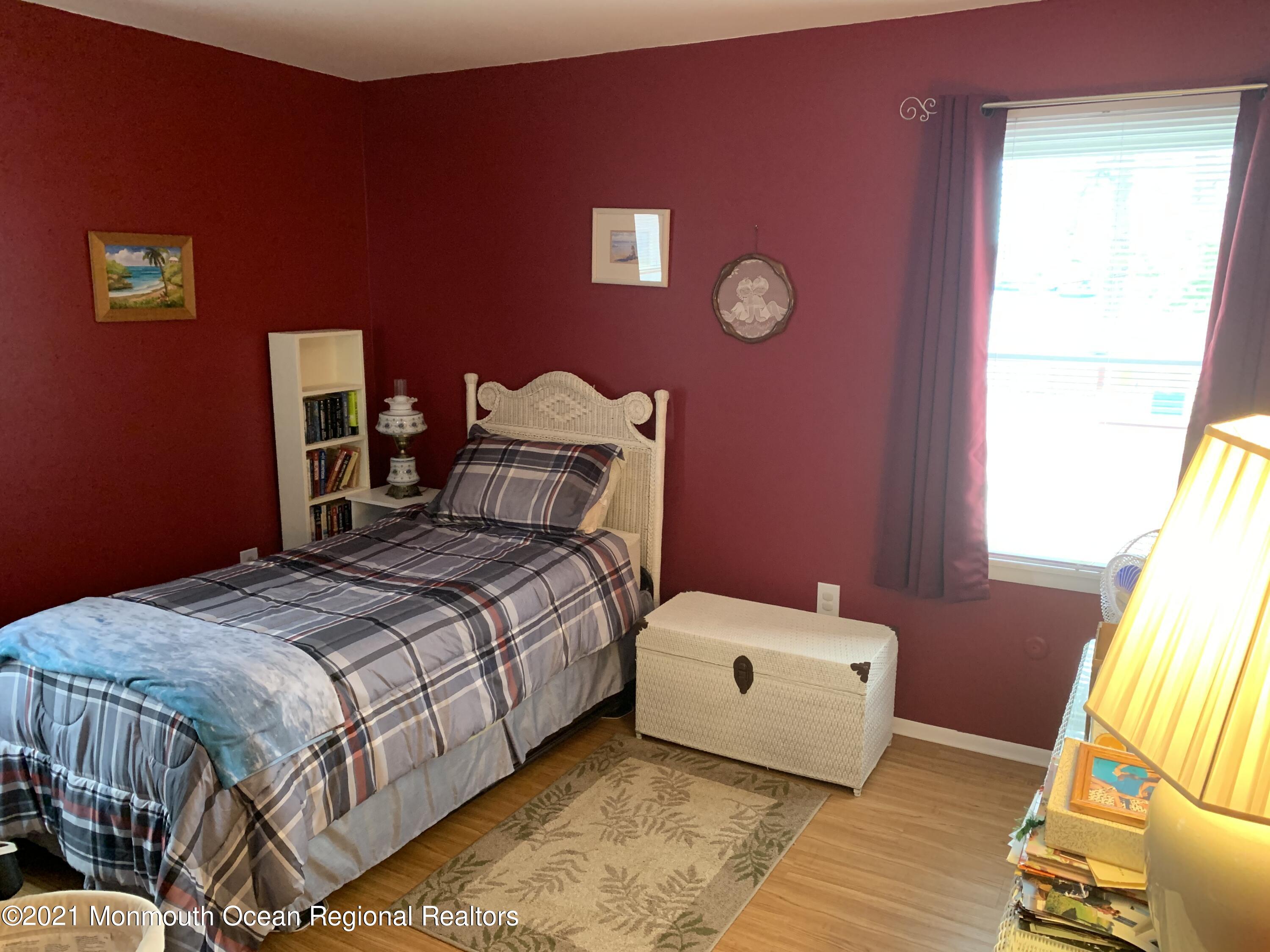 105 Seaspray Road Manahawkin, NJ 08050 - Photo 16 of 25 a bedroom with a bed and wooden floor