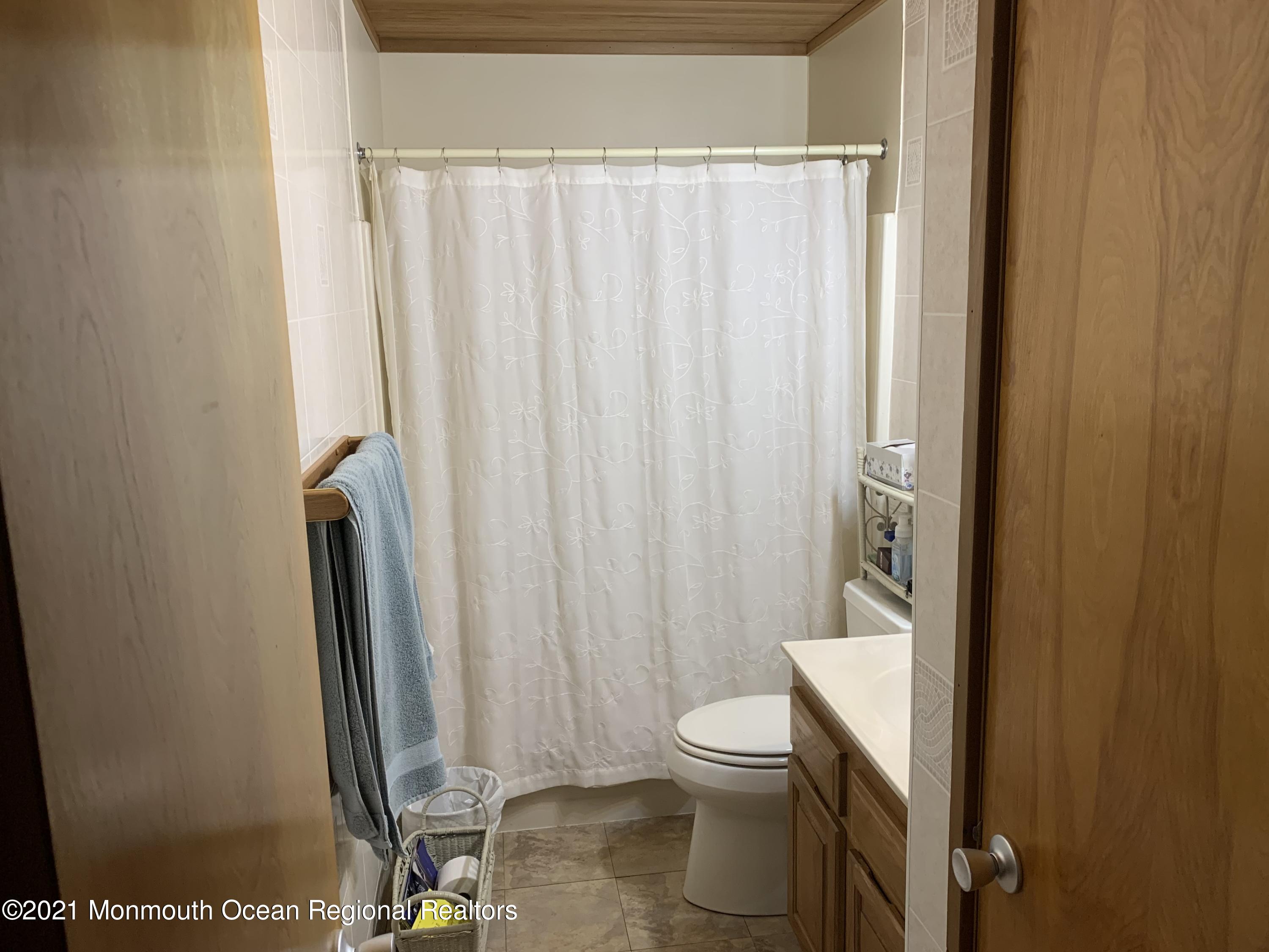 105 Seaspray Road Manahawkin, NJ 08050 - Photo 18 of 25 a bathroom with a toilet and a shower