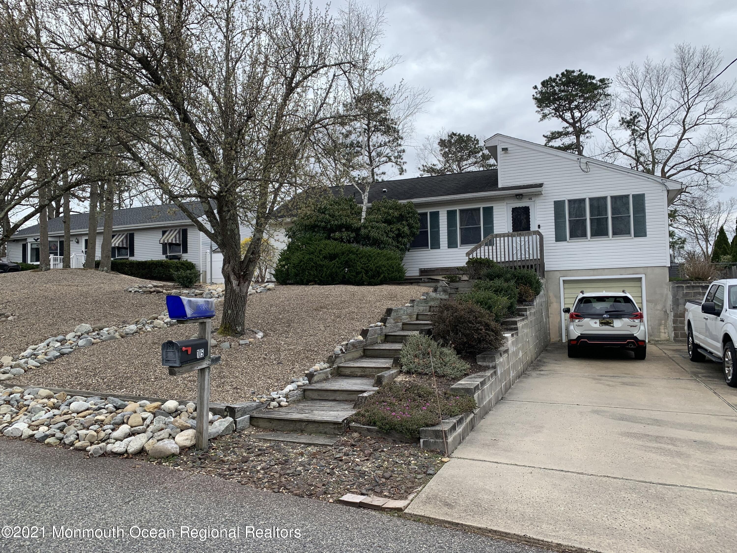 105 Seaspray Road Manahawkin, NJ 08050 - Photo 3 of 25 a view of a house with a cars park side of a road