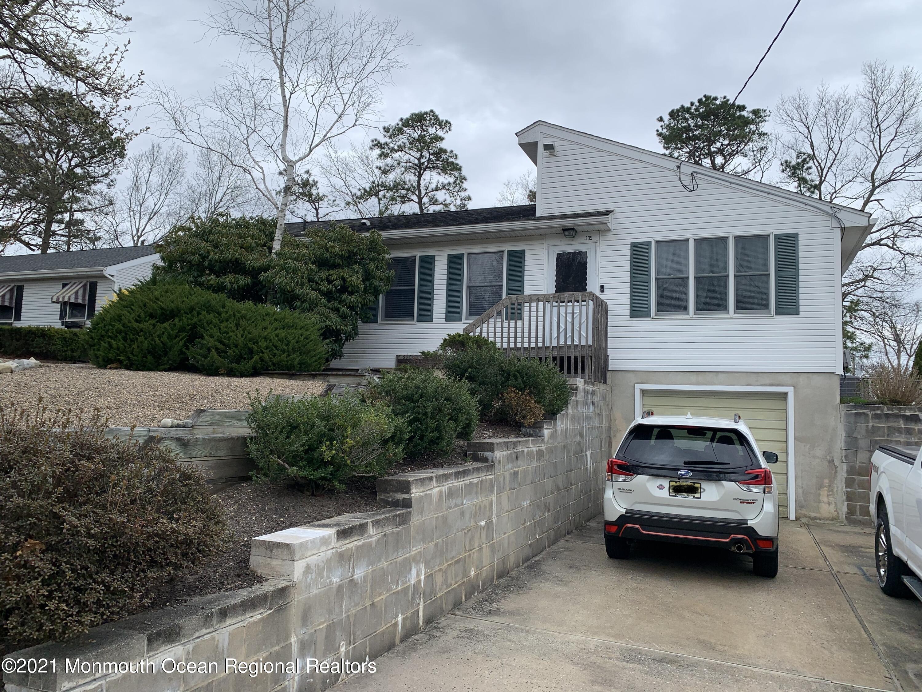 105 Seaspray Road Manahawkin, NJ 08050 - Photo 4 of 25 a car parked in front of a house