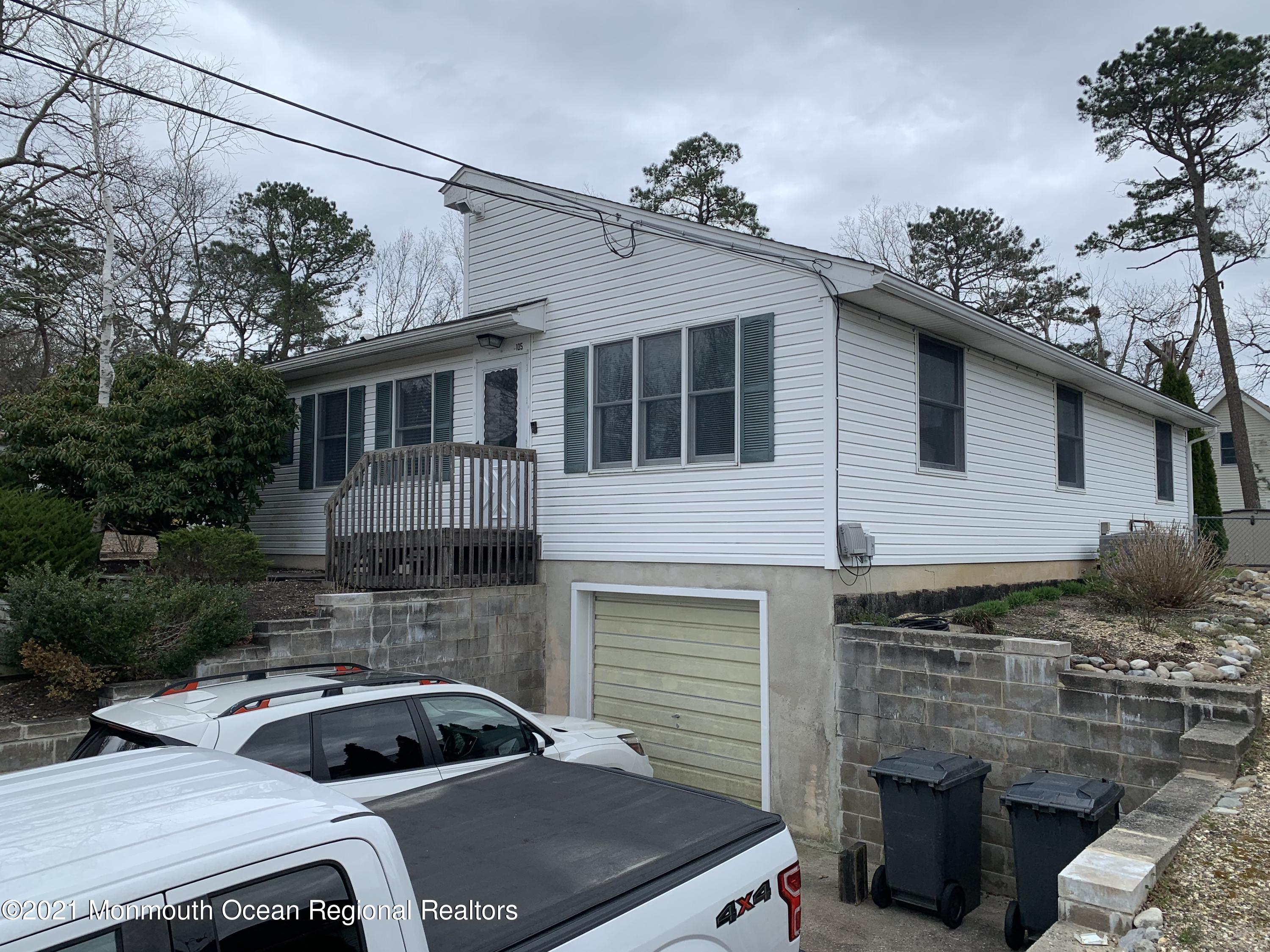 105 Seaspray Road Manahawkin, NJ 08050 - Photo 5 of 25 a front view of a house with parking space