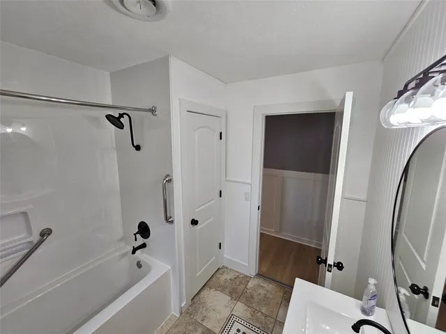 a bathroom with a bathtub a toilet and a shower