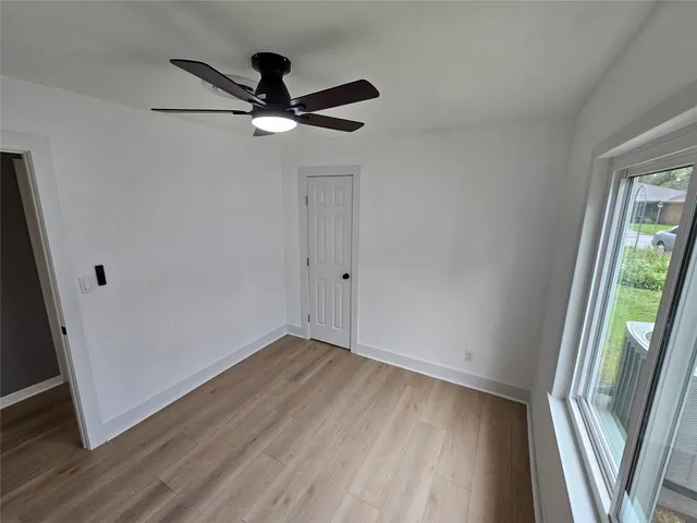 wooden floor in an empty room with a window