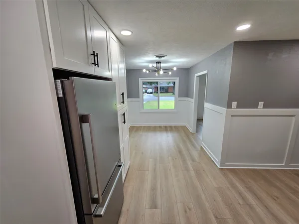 a view of hallway with wooden floor