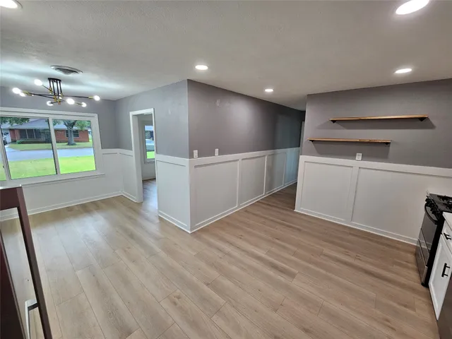 a view of a kitchen with a sink and a refrigerator