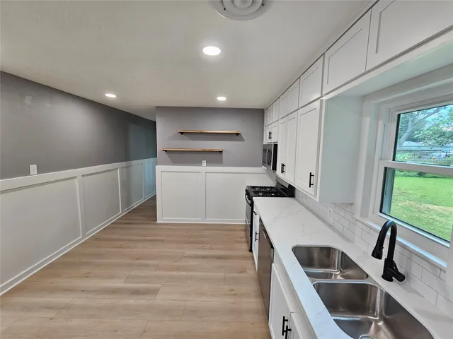a kitchen with a sink stove and refrigerator