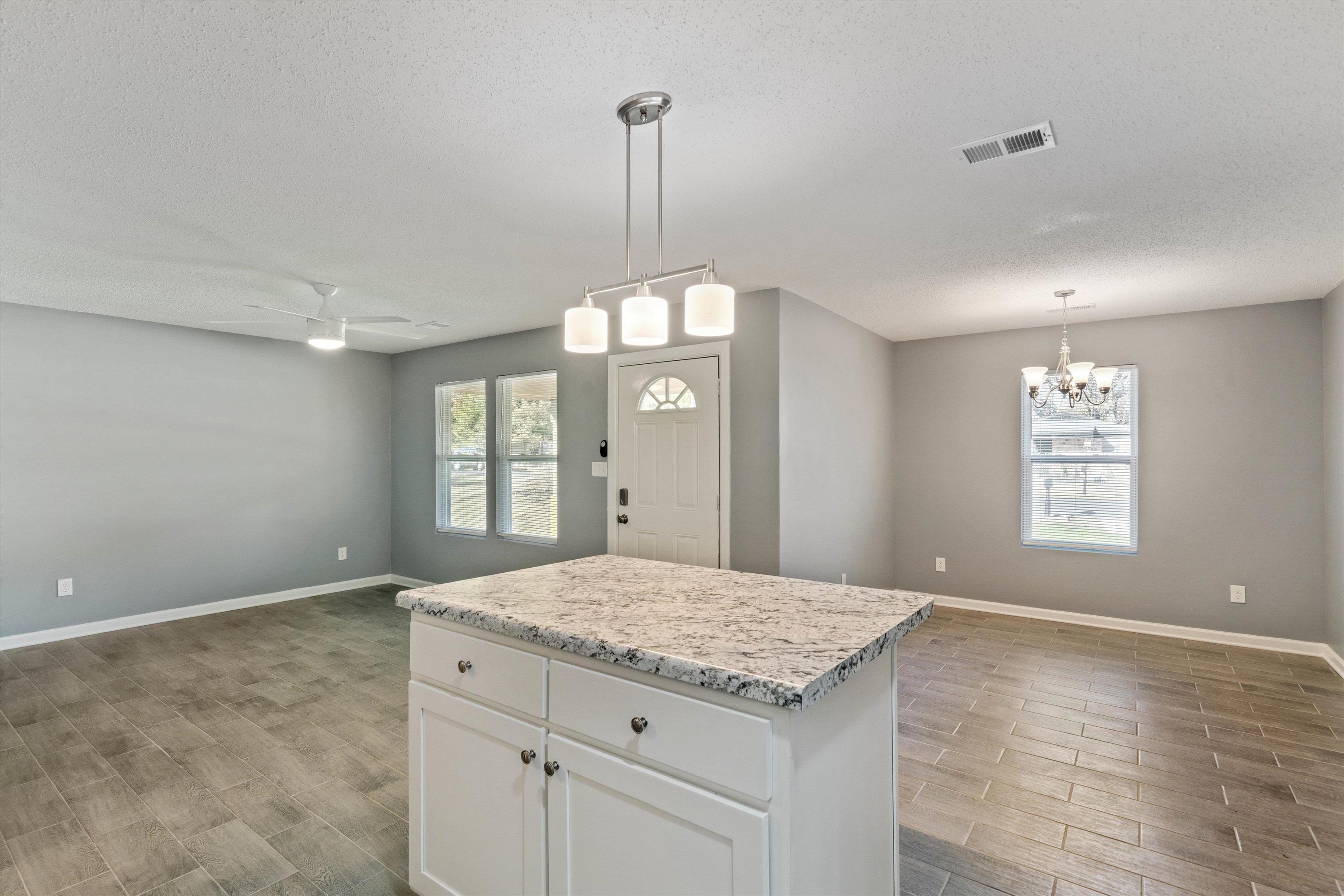 487 Delta Road Memphis, TN 38109 - Photo 12 of 25 a bathroom with a granite countertop sink a window and a mirror